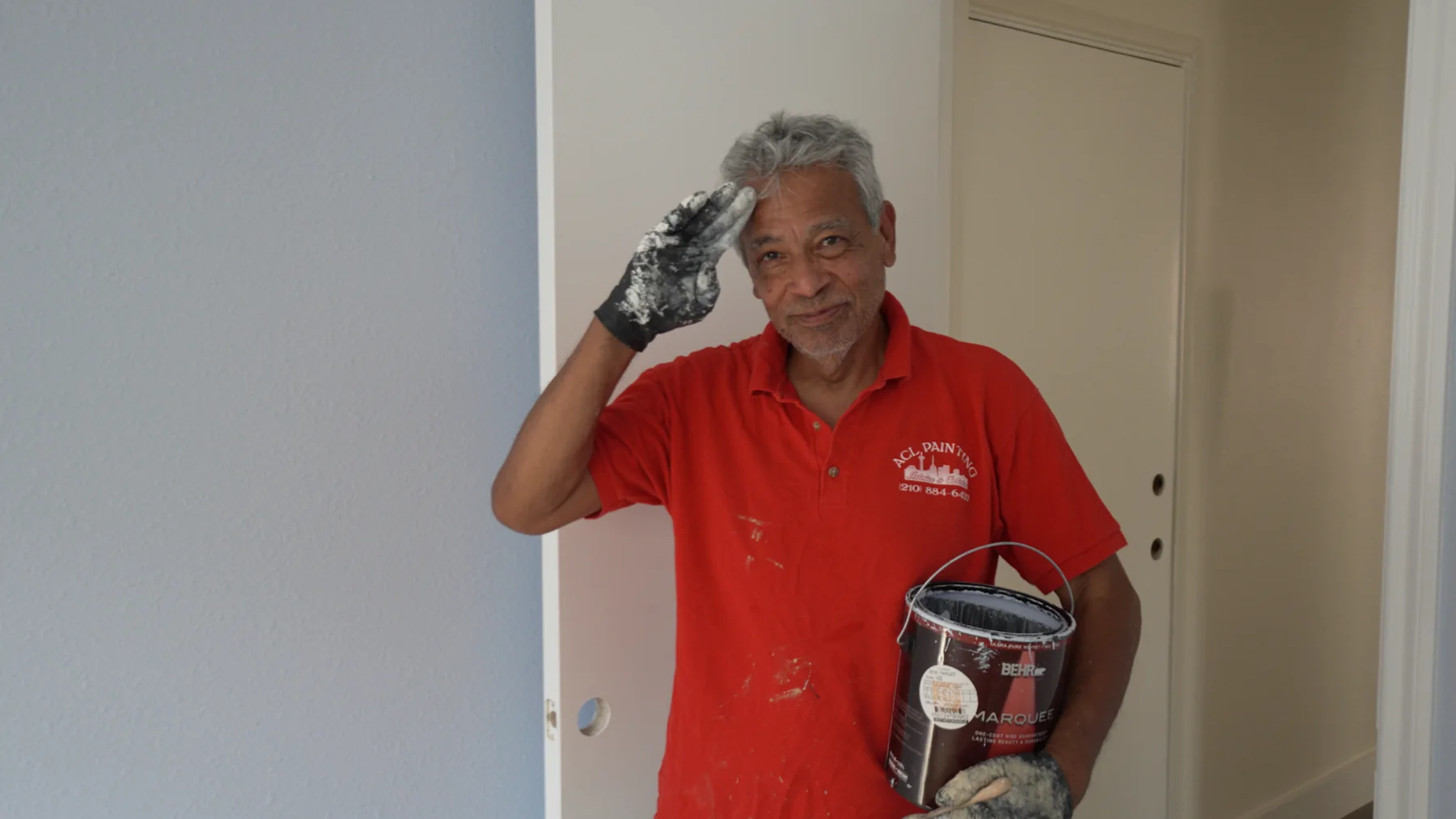 Michael Ramirez, owner of A.C.L. Painting, smiling while working